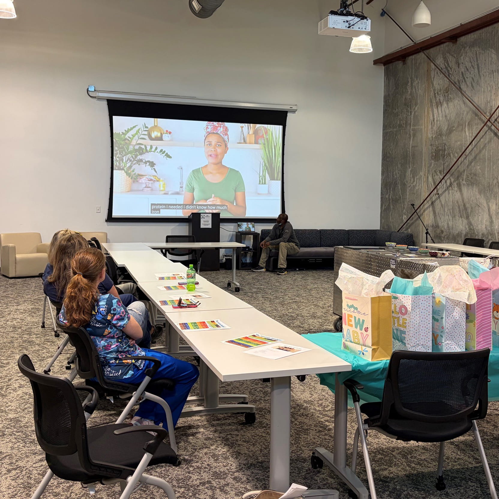 Classroom of people viewing a presentation about how to eat healthy during their pregnancy
