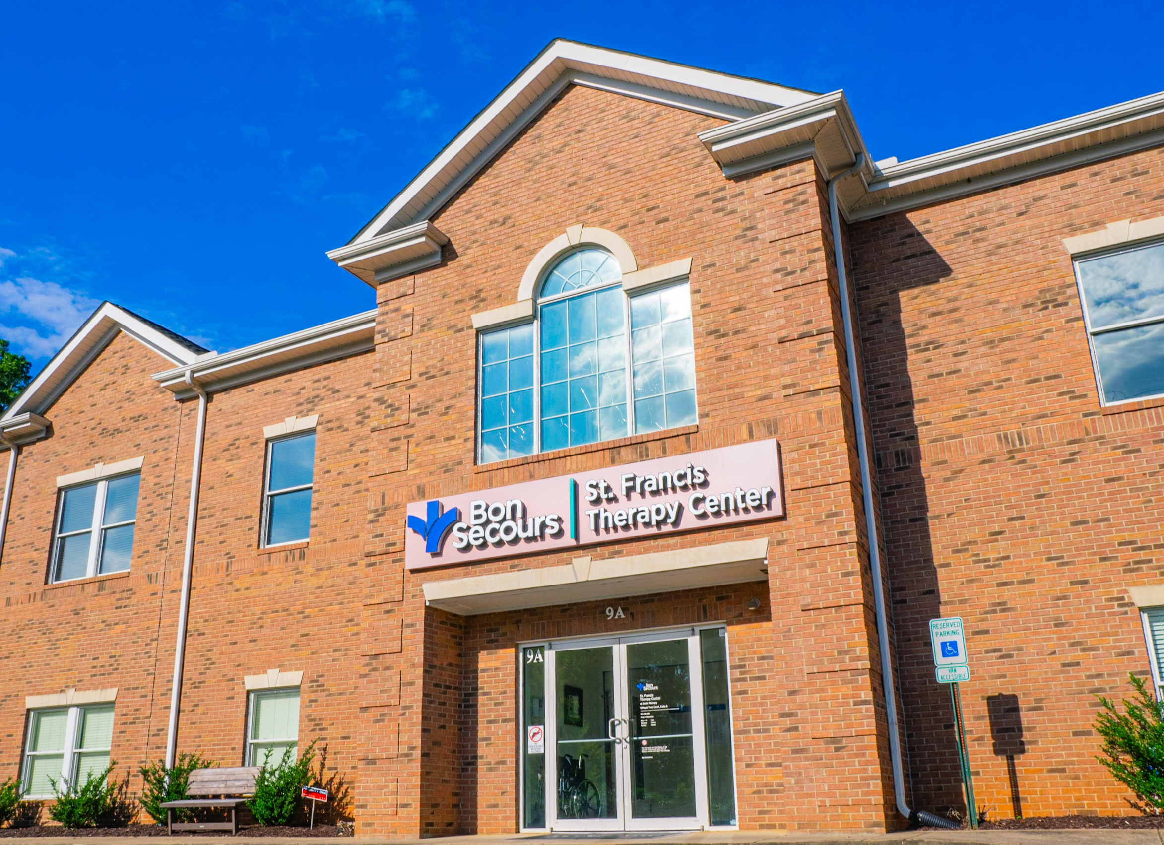 Modern brick building with Bon Secours sign over entrance.