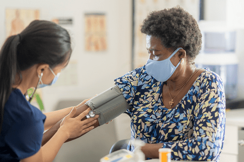 cardiologist monitoring blood pressure with a blood pressure cuff
