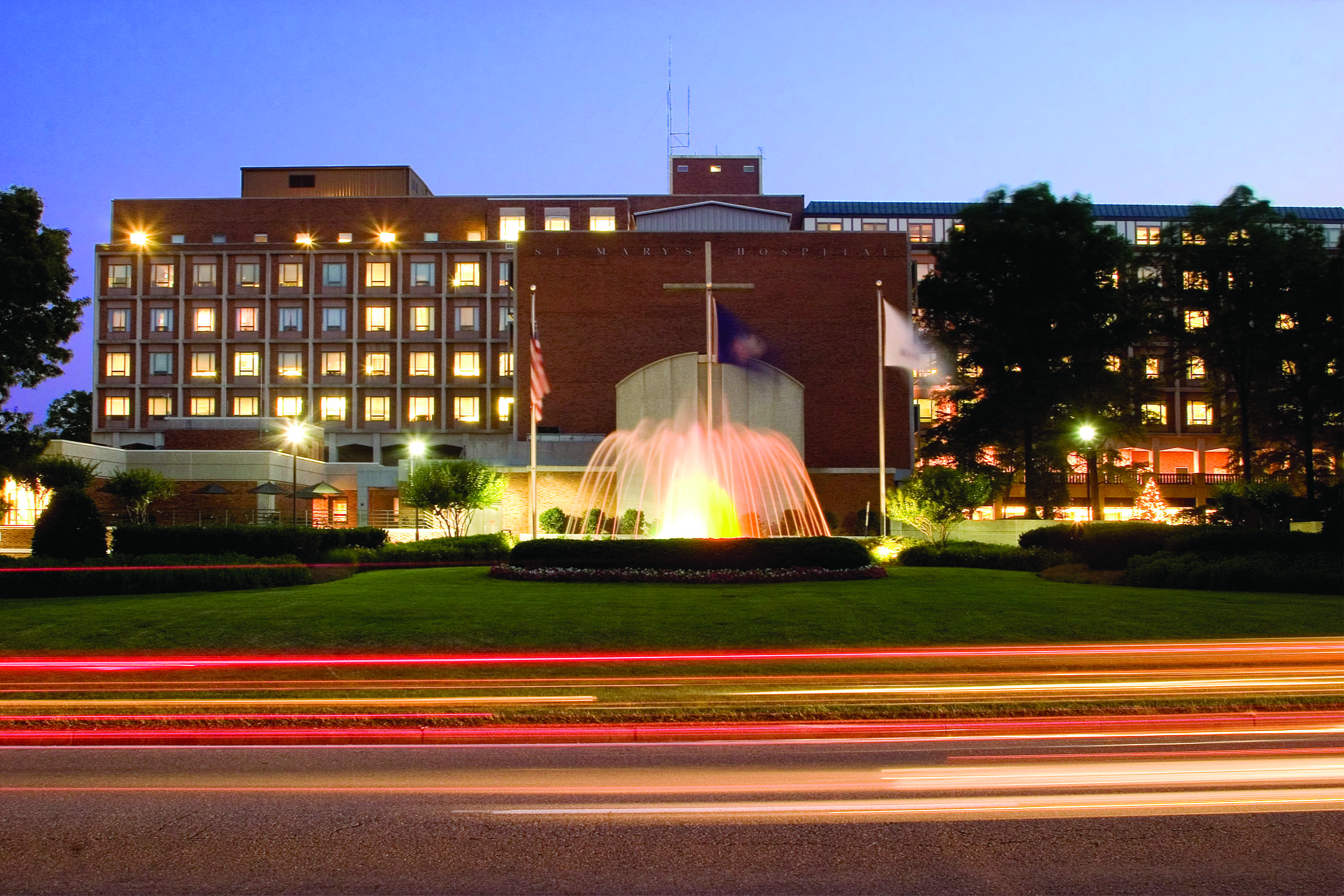 Exterieor view of the front of St. Mary's in Richmond with fountain lit up at night.