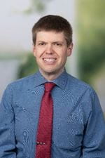 Gregor Stevens. white male appearing blue shirt with red tie