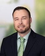 Joshua Crawford. Male wearing a suite with green shirt and green tie.