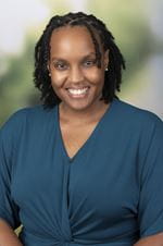 Andrea Hobbs headshot. Woman in a green top.
