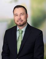 Joshua Crawford, PharmD, BCPS  male in a dark suit.