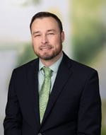 Joshua Crawford, PharmD, BCPS  male in a dark suit.